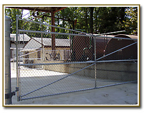 Security fence for hazardous liquid tank area